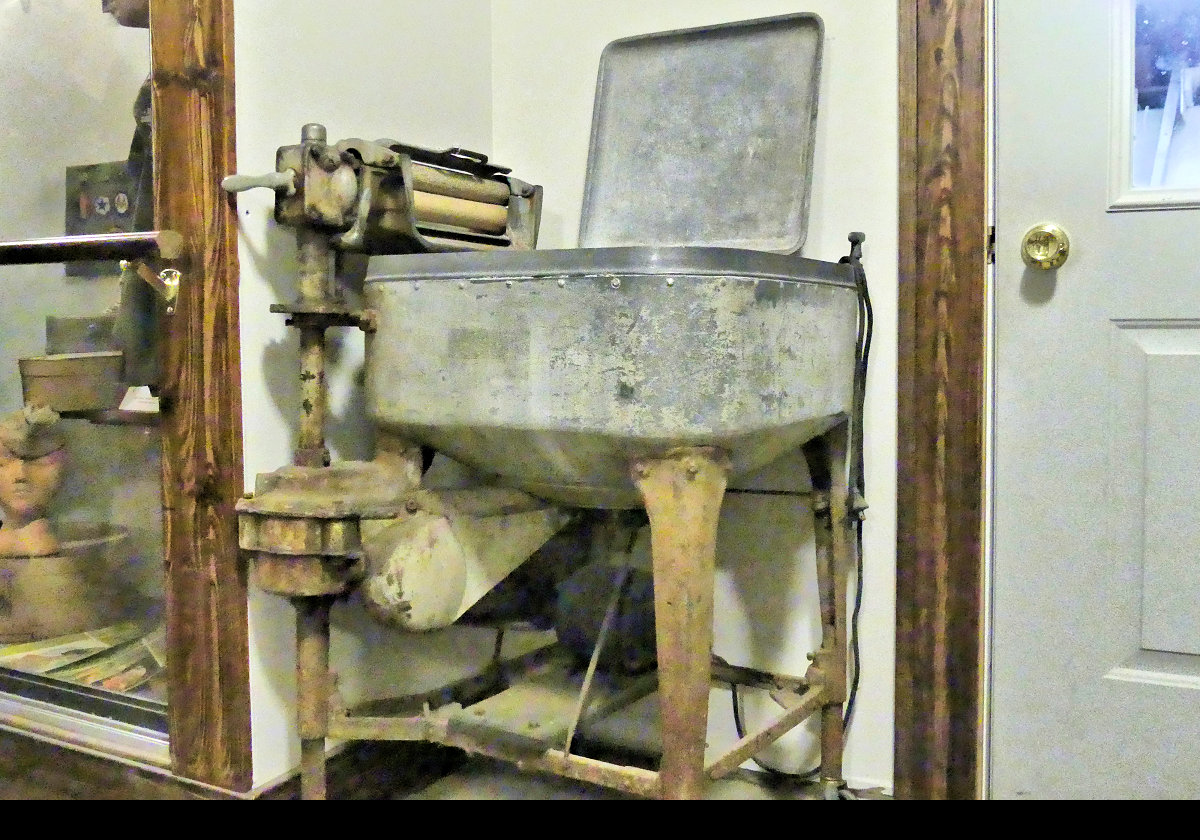 Doing the washing 1940s style. By hand with a "Mangle" for drying. Then hang it all up on the washing line in your back yard.