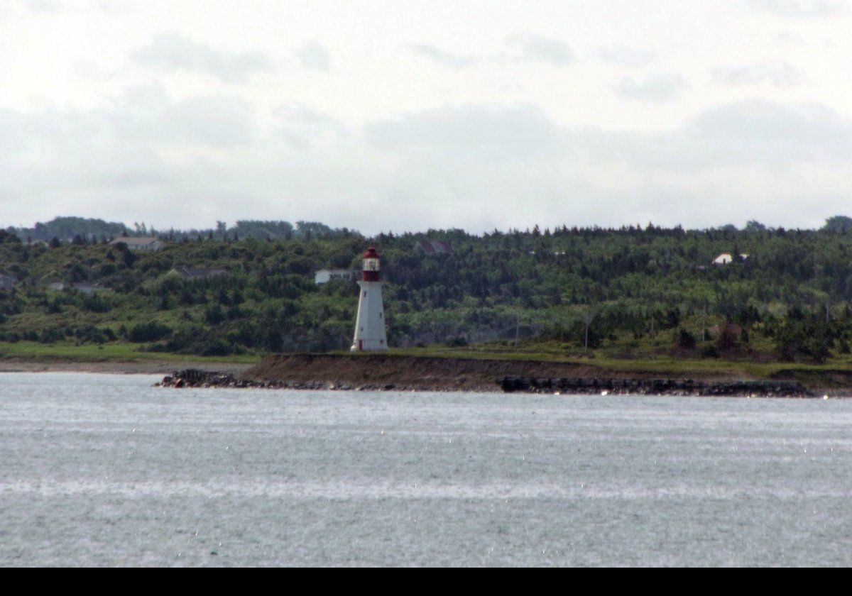 The Low Point Lighthouse at the eastern entrance to Sydney Harbour near New Victoria, Nova Scotia.